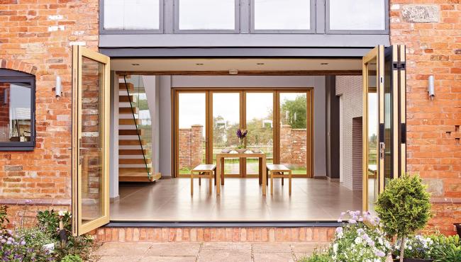 Two Centor Folding Doors with wood interior creating indoor outdoor flow
