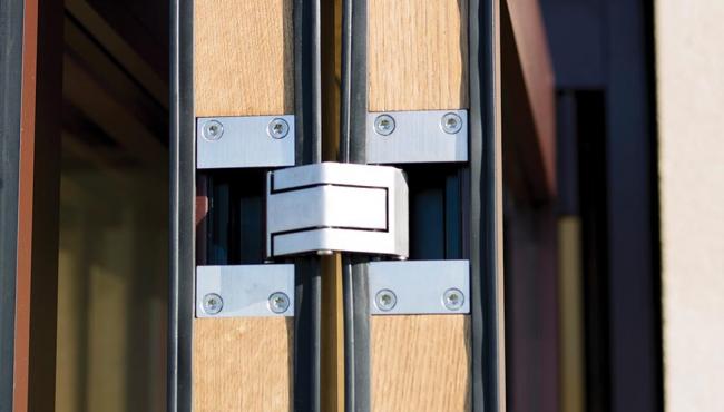 Folding door hinge is hidden from sight within the edge of the door